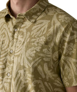 Close up of chest pocket on the Patagonia men's buttoned short sleeve shirt in light green and a repeating abstract pattern 