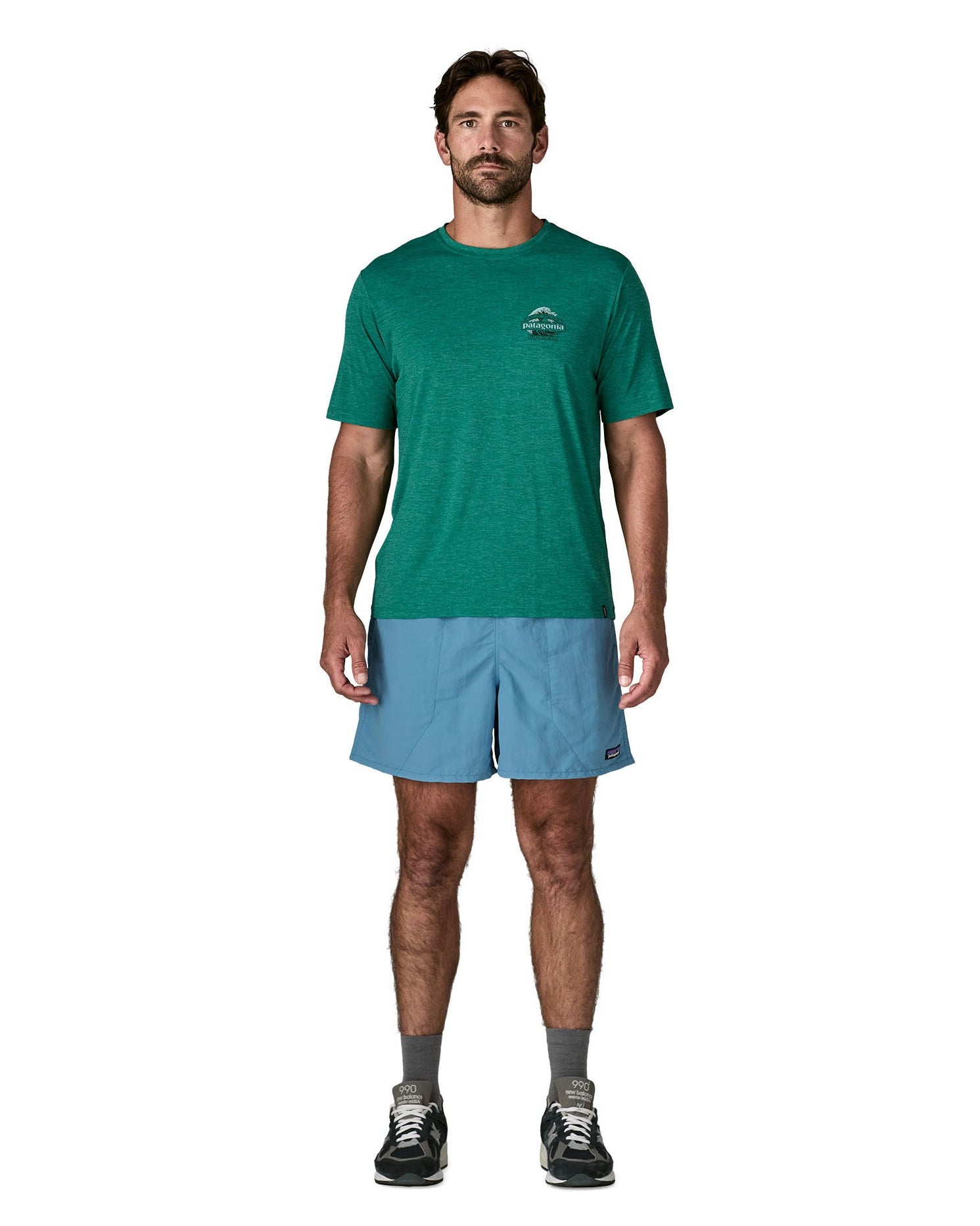 Man wearing Patagonia's men's  quick drying baggies shorts in light blue. Shorts have loose fitting 
