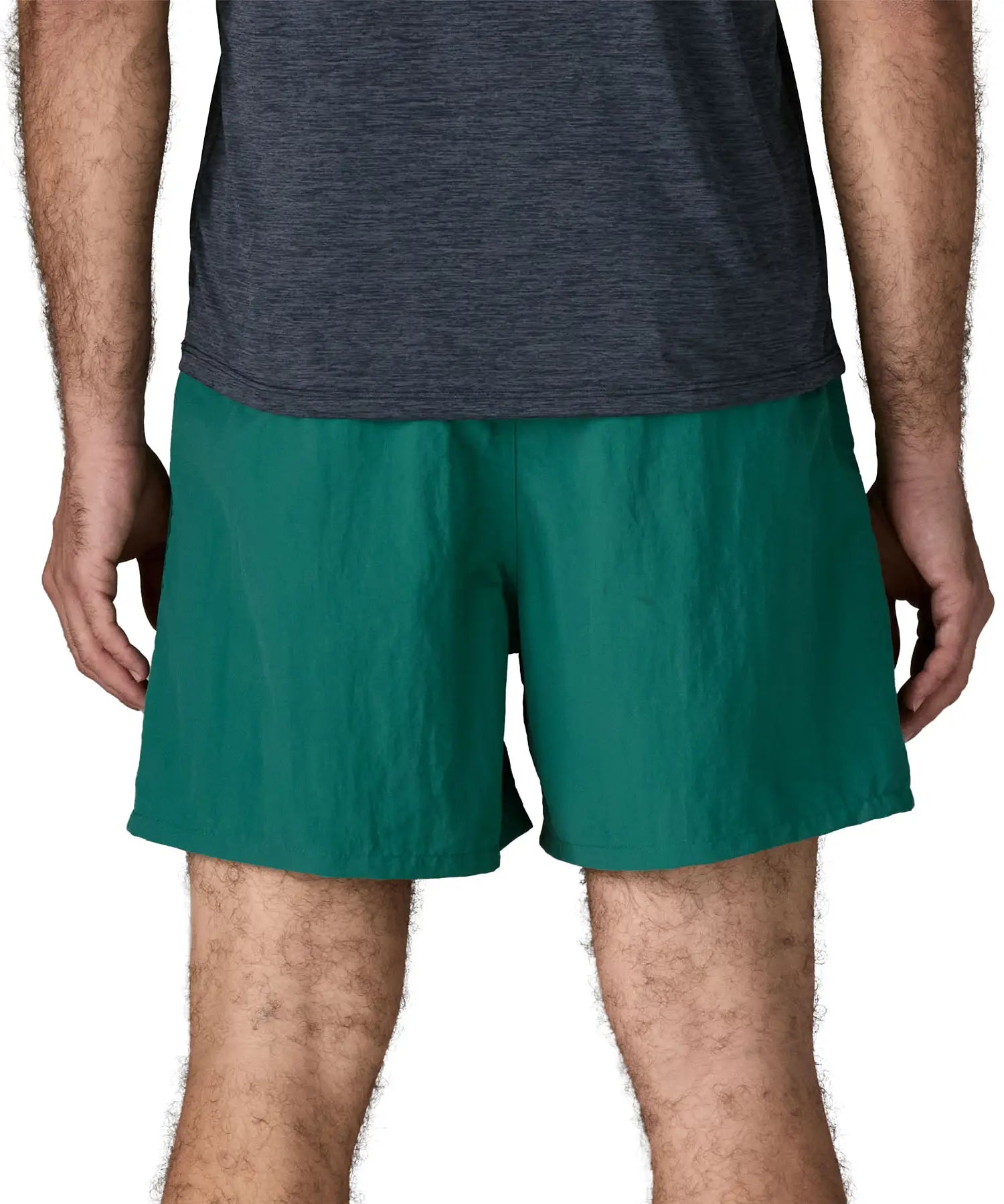 Back of man wearing Patagonia's men's  quick drying baggies shorts in teal green. Shorts have loose fitting and sit above the knees