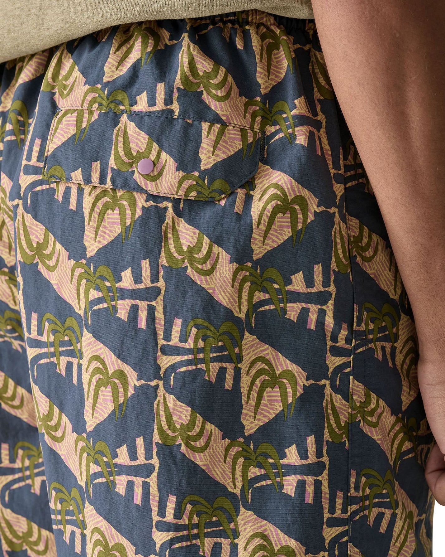 Patagonia's men's quick drying men's baggies shorts with repeating abstract tropical design. Shows back pocket with popper fastener