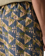 Patagonia's men's quick drying men's baggies shorts with repeating abstract tropical design. Shows back pocket with popper fastener