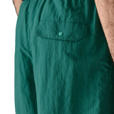 Patagonia's men's quick drying baggies shorts in teal green. Shows back pocket with popper fastener