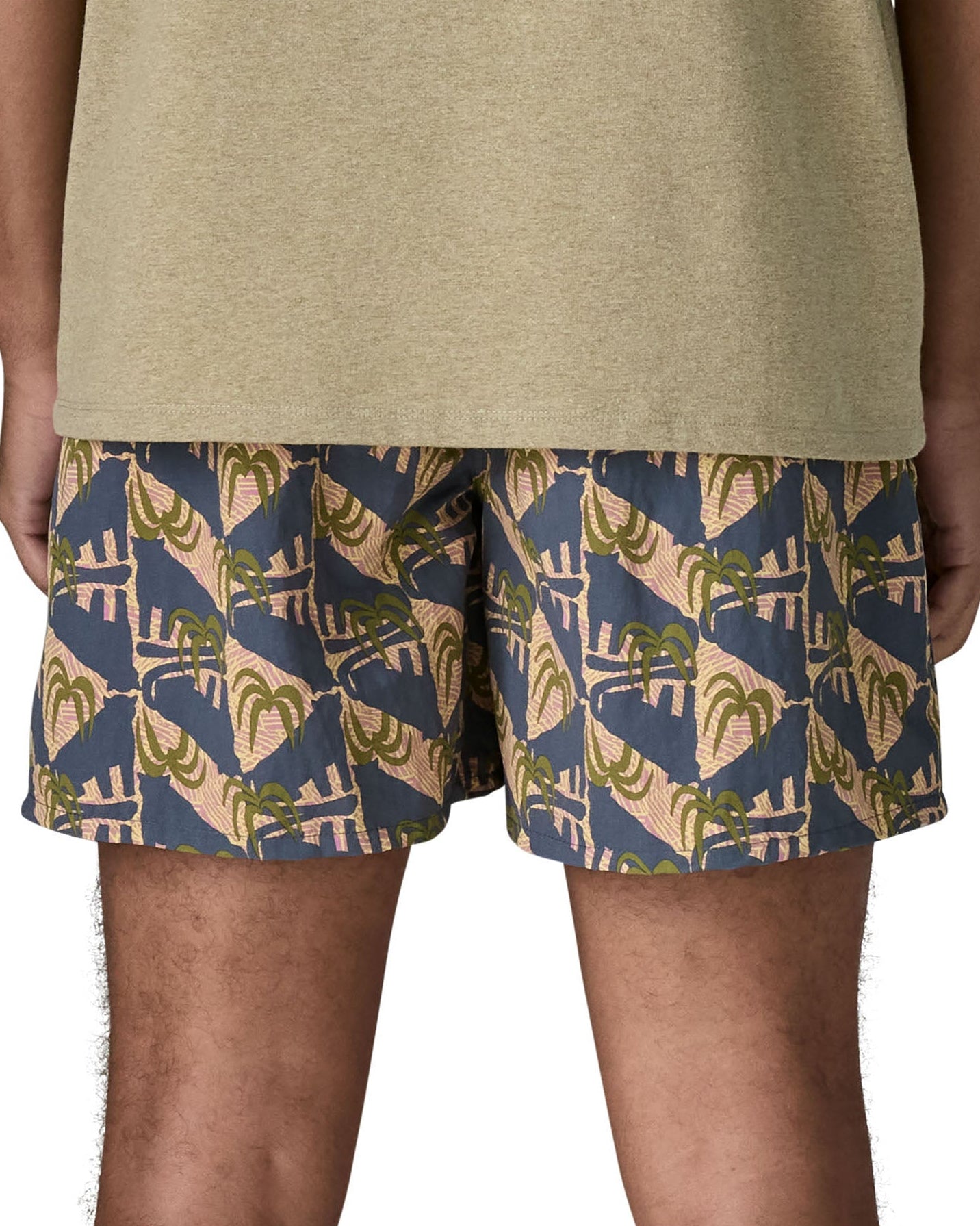 Back of man wearing Patagonia's men's  quick drying baggies shorts with repeating abstract tropical. Shorts have loose fitting and sit above the knees