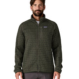 A man wearing the Patagonia men's better sweater in scales/old growth green available at Babipur. A light and dark green with a scales pattern lightweight fleece style jacket with full length zip, 2 side pockets, a chest pocket and features the brand logo patch stitched on the left chest 