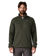 A man wearing the Patagonia men's better sweater in scales/old growth green available at Babipur. A light and dark green with a scales pattern lightweight fleece style jacket with full length zip, 2 side pockets, a chest pocket and features the brand logo patch stitched on the left chest 