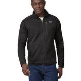 Man wearing Patagonia's better sweater in black. Jacket has a regular fit and sits around the hips