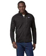 Man wearing Patagonia's better sweater in black. Jacket has a regular fit and sits around the hips