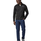 Man wearing Patagonia's better sweater in black. Shows the full length zip, pockets and zippered chest pocket