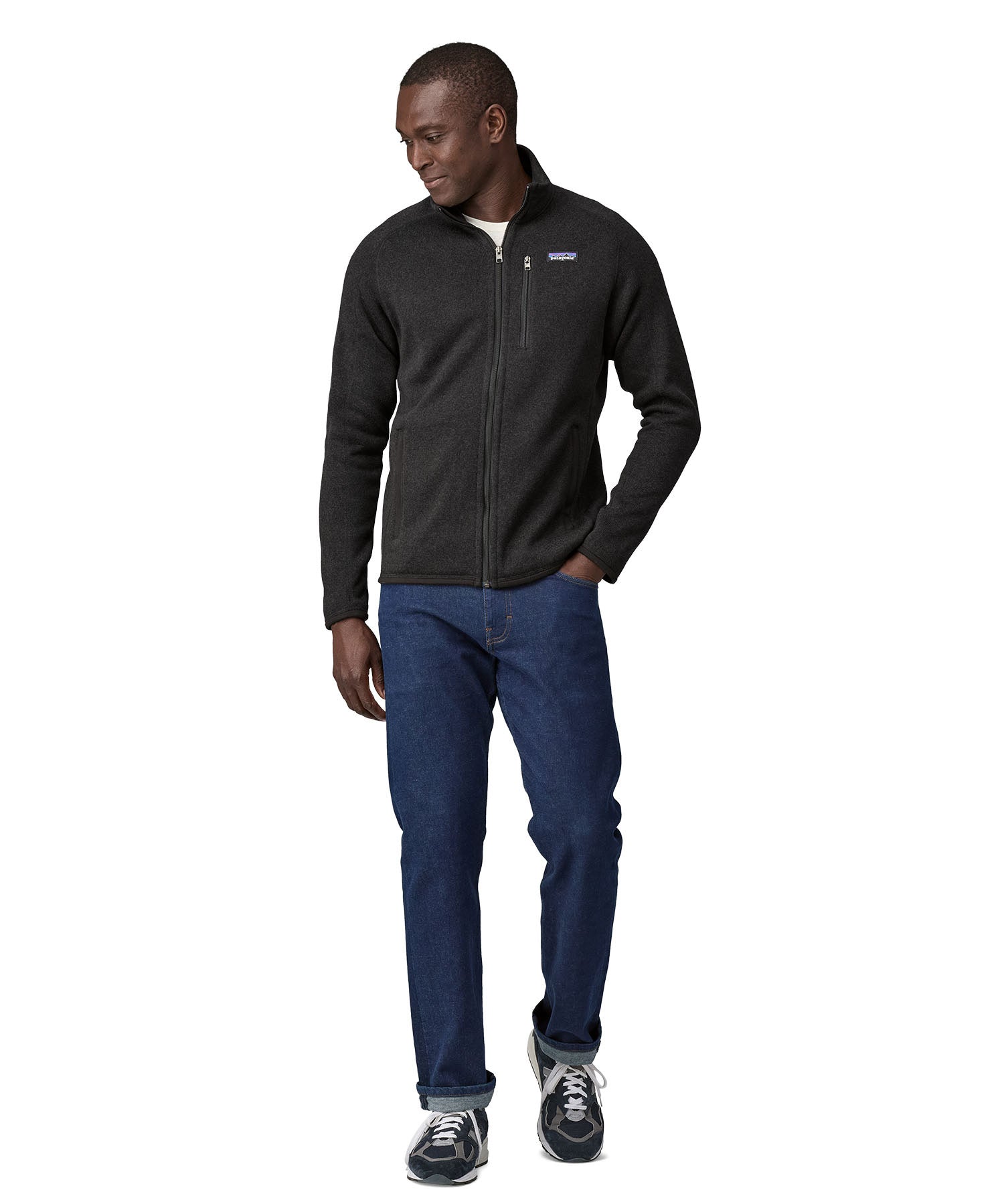 Man wearing Patagonia's better sweater in black. Shows the full length zip, pockets and zippered chest pocket