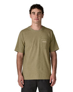 Man wearing the Patagonia's men's boardshort logo responsibili tee in light green. Shows a small pouch pocket on the chest.