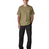 Man wearing Patagonia's men boardshort logo pocket responsibili tee in light green. T-shirt has a classic crewneck design