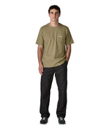 Man wearing Patagonia's men boardshort logo pocket responsibili tee in light green. T-shirt has a classic crewneck design