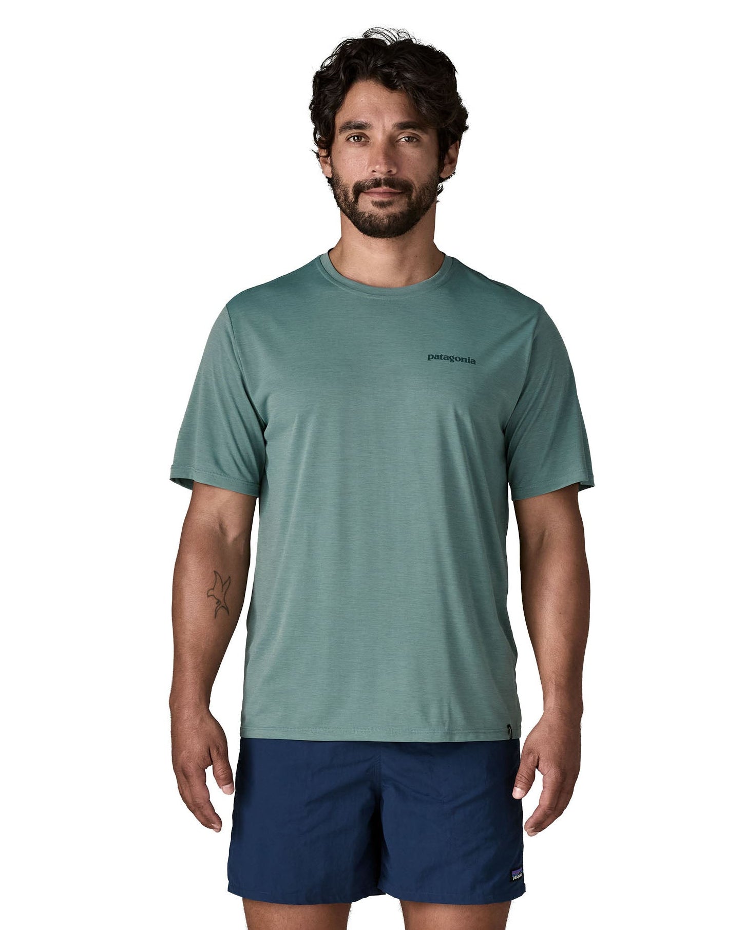 Man wearing Patagonia's men's capilene cool daily t-shirt in sage blue with small brand text on chest. 