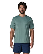 Man wearing Patagonia's men's capilene cool daily t-shirt in sage blue with small brand text on chest. 