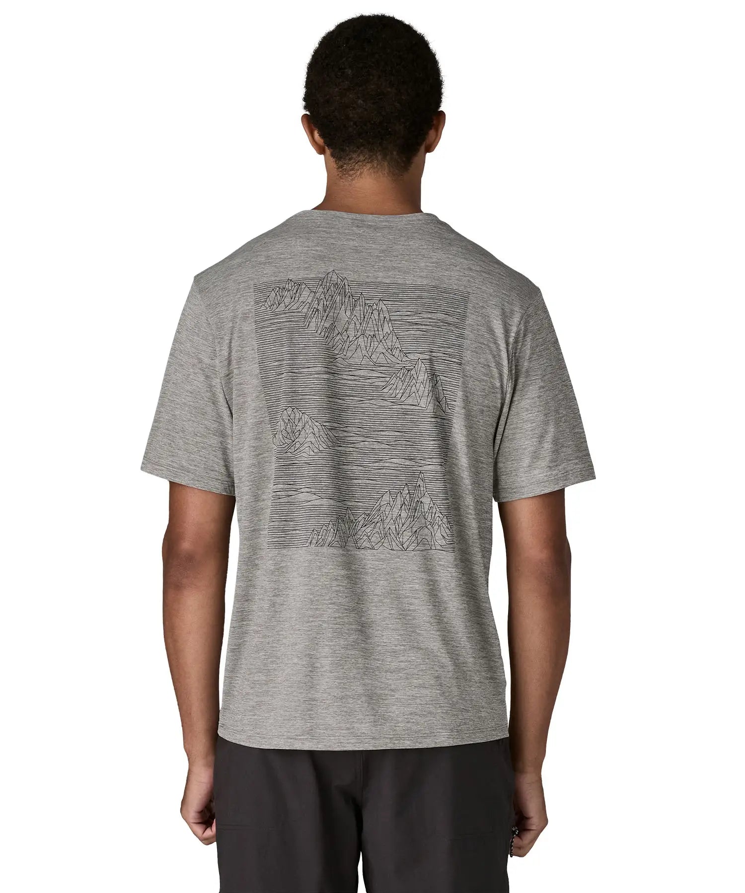 Man wearing Patagonia men's capilene cool daily short sleeve t-shirt in grey with large mountain brand logo on back
