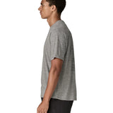 Side of man wearing Patagonia men's capilene cool daily short sleeve t-shirt in grey. T-shirt has a relaxed fit