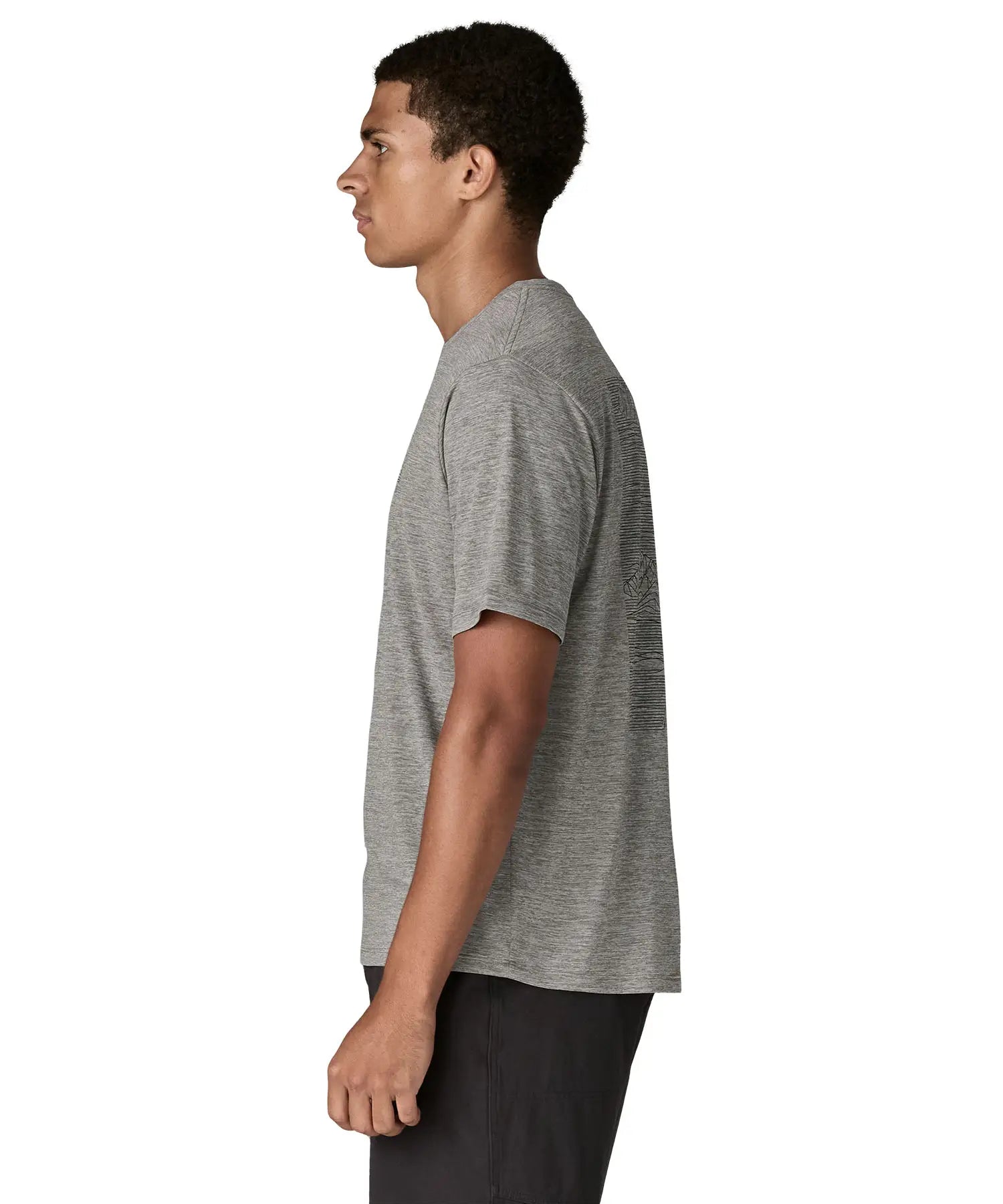 Side of man wearing Patagonia men's capilene cool daily short sleeve t-shirt in grey. T-shirt has a relaxed fit