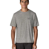 Man wearing Patagonia men's capilene cool daily short sleeve t-shirt in grey with small white brand logo on chest