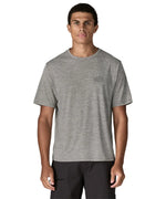 Man wearing Patagonia men's capilene cool daily short sleeve t-shirt in grey with small white brand logo on chest