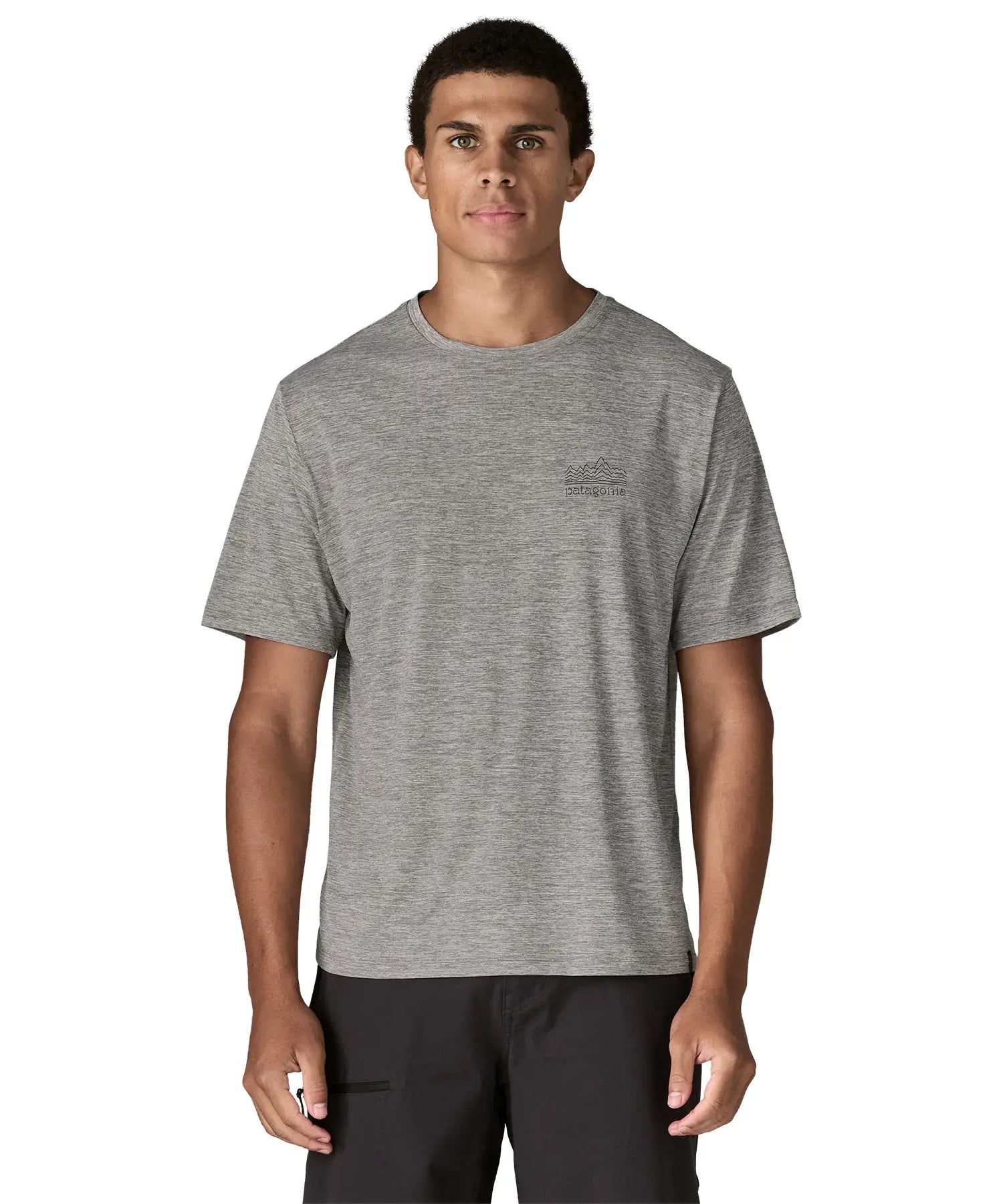 Man wearing Patagonia men's capilene cool daily short sleeve t-shirt in grey with small white brand logo on chest