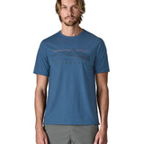 Man wearing Patagonia men's capilene trail short sleeve t-shirt in blue with mountain outline graphic on upper body