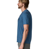 Side of wan wearing Patagonia men's capilene trail short sleeve t-shirt in blue, t-shirt has a relaxed fit and sits at the hips