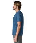 Side of wan wearing Patagonia men's capilene trail short sleeve t-shirt in blue, t-shirt has a relaxed fit and sits at the hips