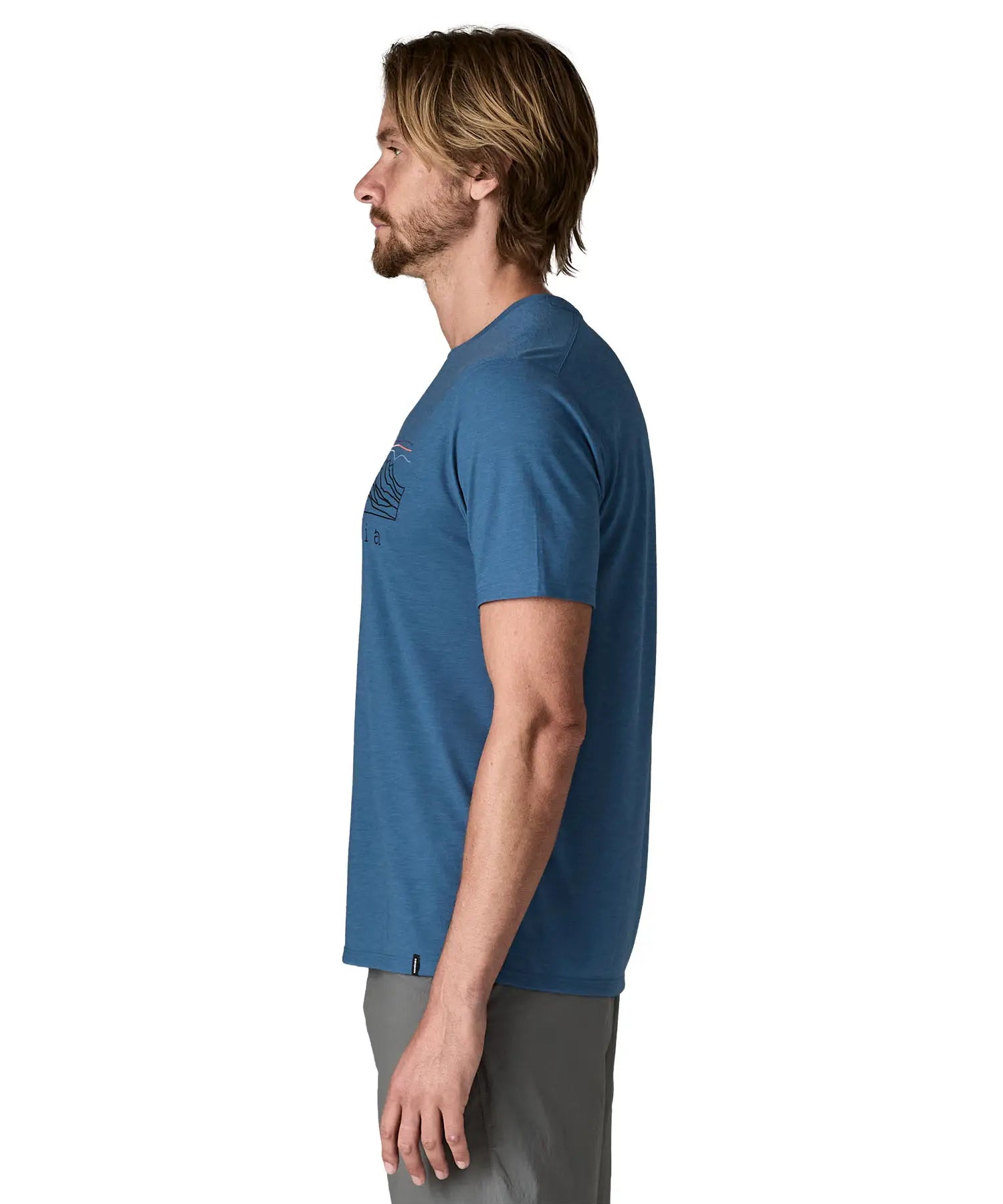Side of wan wearing Patagonia men's capilene trail short sleeve t-shirt in blue, t-shirt has a relaxed fit and sits at the hips