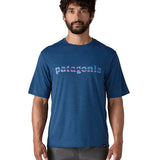 A man wearing the Patagonia blue capilene cool daily short sleeve tshirt in clement with branding on the front available at Babipur