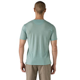 The back of a man wearing The Patagonia Men's Capilene Cool Merino Graphic T-Shirt in thermal blue