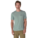 A man wearing The Patagonia Men's Capilene Cool Merino Graphic T-Shirt in thermal blue