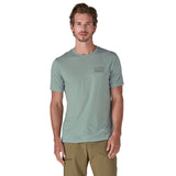 A man wearing The Patagonia Men's Capilene Cool Merino Graphic T-Shirt in thermal blue
