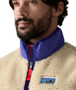 A close up of the Patagonia mens classic retro x fleece vest available at Babipur showing the royal blue turn up collar detail