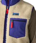 A close up of the Patagonia mens classic retro x fleece vest available at Babipur showing the royal blue chest pocket detail