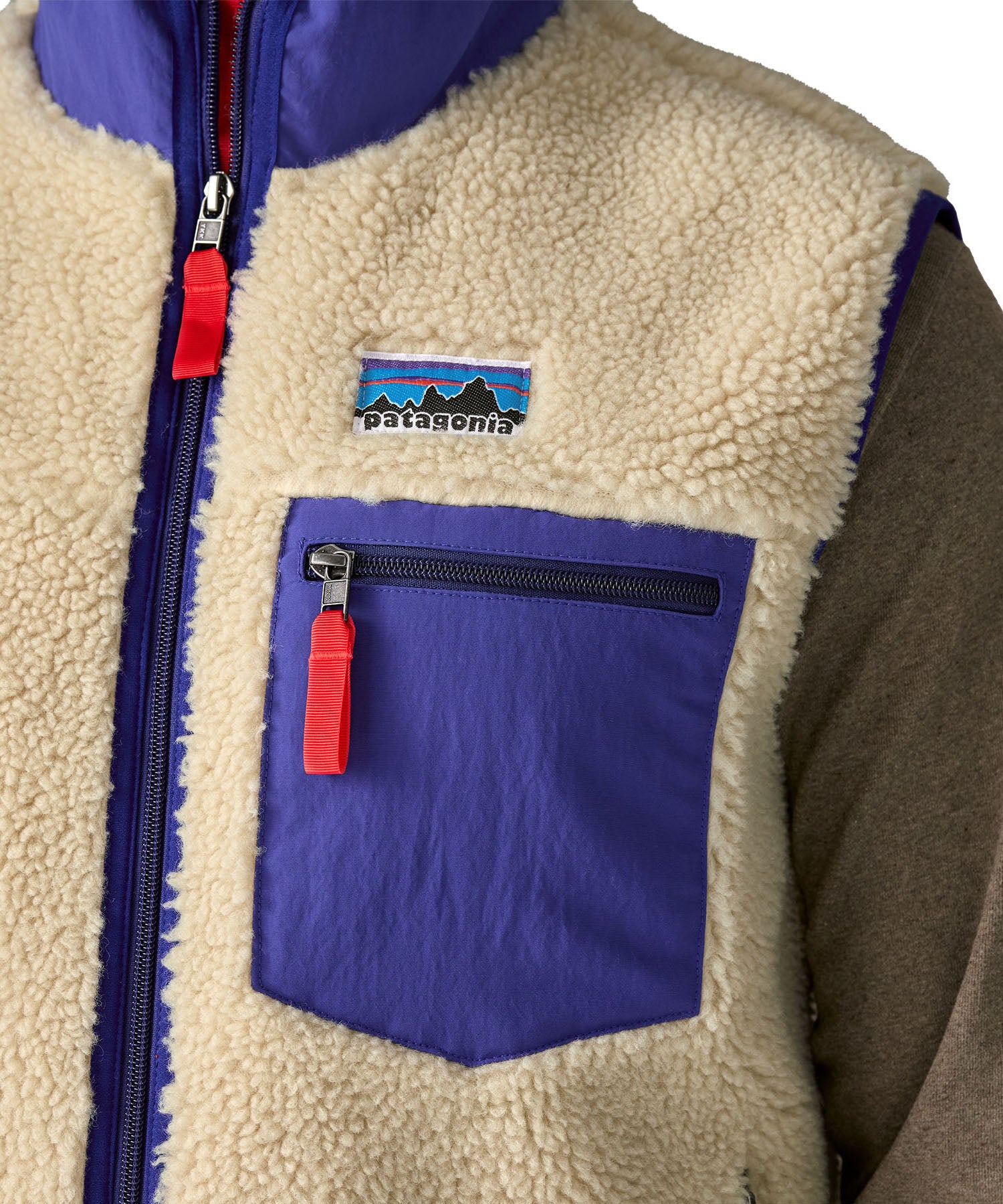A close up of the Patagonia mens classic retro x fleece vest available at Babipur showing the royal blue chest pocket detail