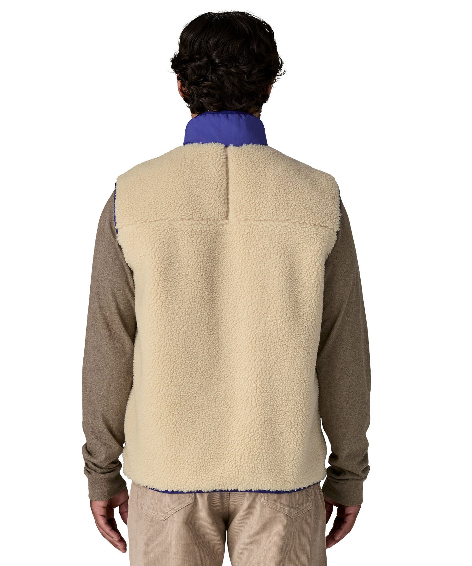 A model wearing the Patagonia mens classic retro x fleece vest available at Babipur showing the back fit of the gilet