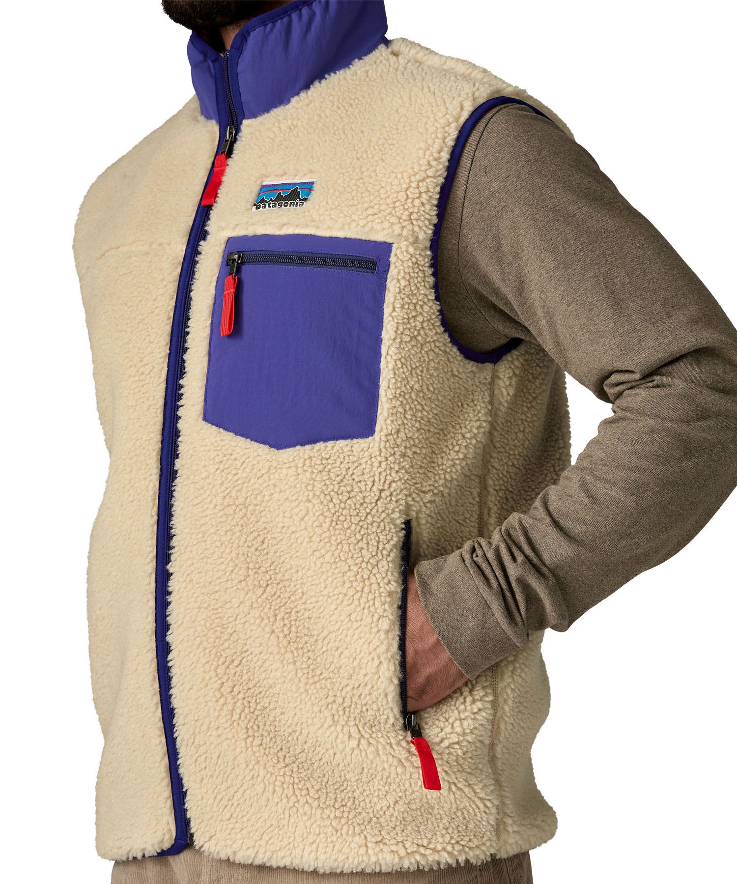 A close up of the Patagonia mens classic retro x fleece vest available at Babipur showing the side pocket and arm hole detail