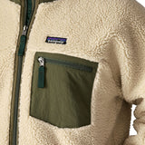 A close up of the Patagonia classic retro x jacket in natural/green available at Babipur showing the green chest pocket panel detail