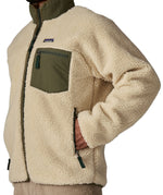 A close up of the Patagonia classic retro x jacket in natural/green available at Babipur showing the side pocket detail