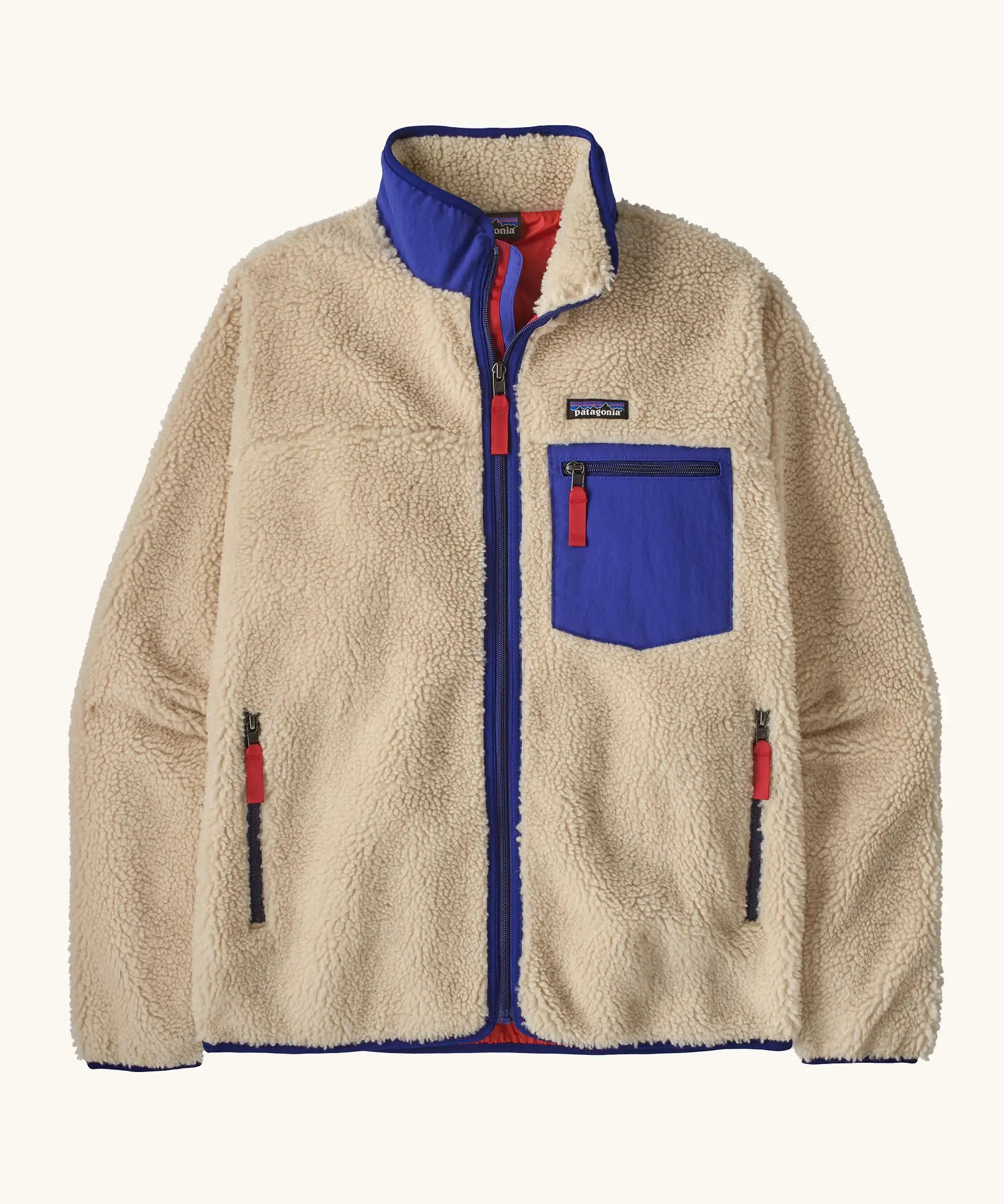 Patagonia Men’s Classic Retro-X Fleece Jacket in beige with cobalt blue trim. Features a full front zip, chest and side pockets
