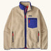 Patagonia Men’s Classic Retro-X Fleece Jacket in beige with cobalt blue trim. Features a full front zip, chest and side pockets