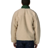 Back of man wearing the Patagonia classic retro x jacket in natural showing the green turned up collar