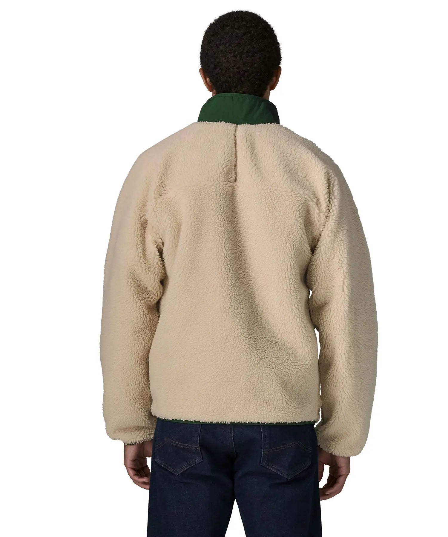 Back of man wearing the Patagonia classic retro x jacket in natural showing the green turned up collar