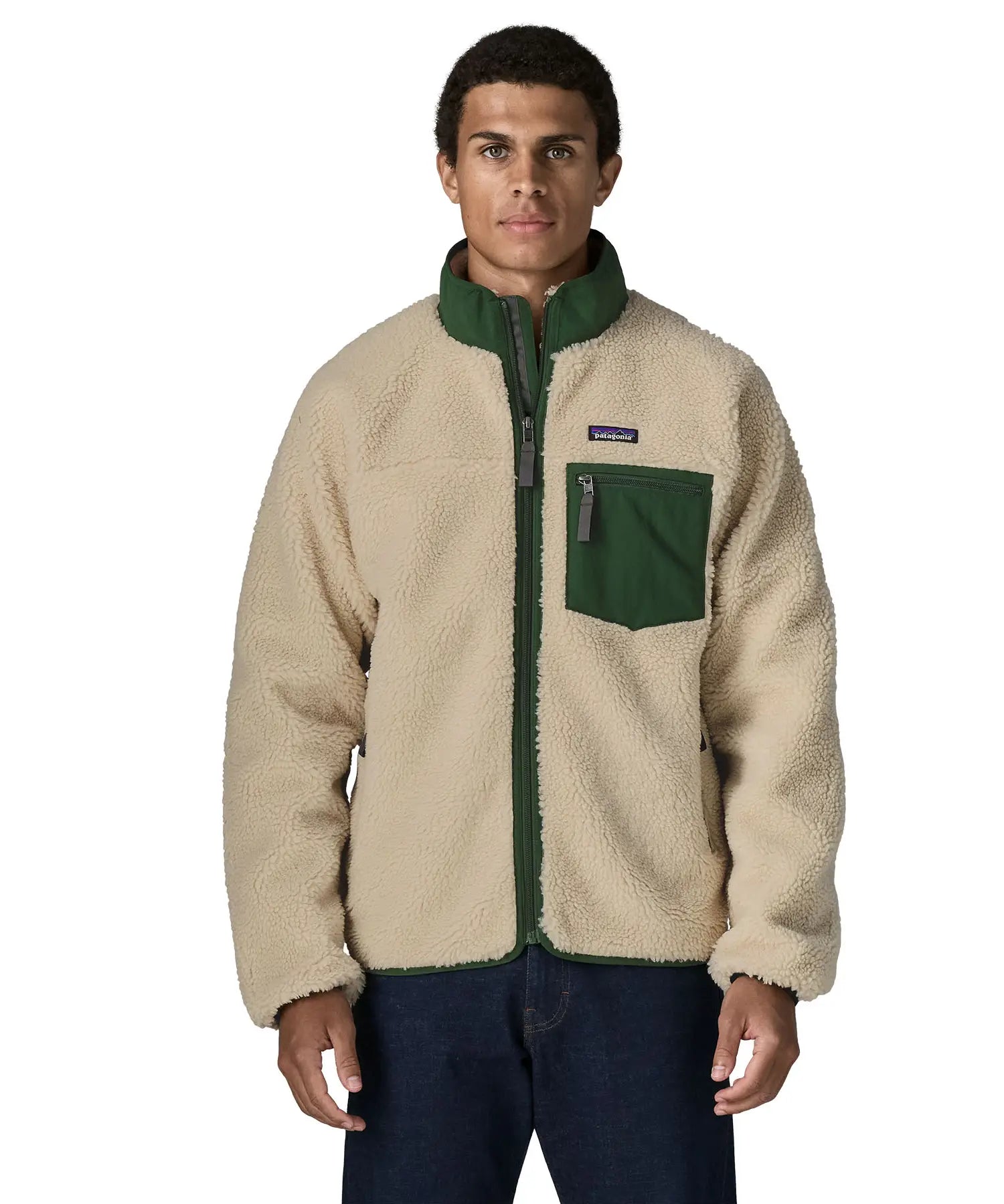 Man wearing the Patagonia classic retro x jacket in natural with green trim. Showing front zip, chest pocket and turned up collar 