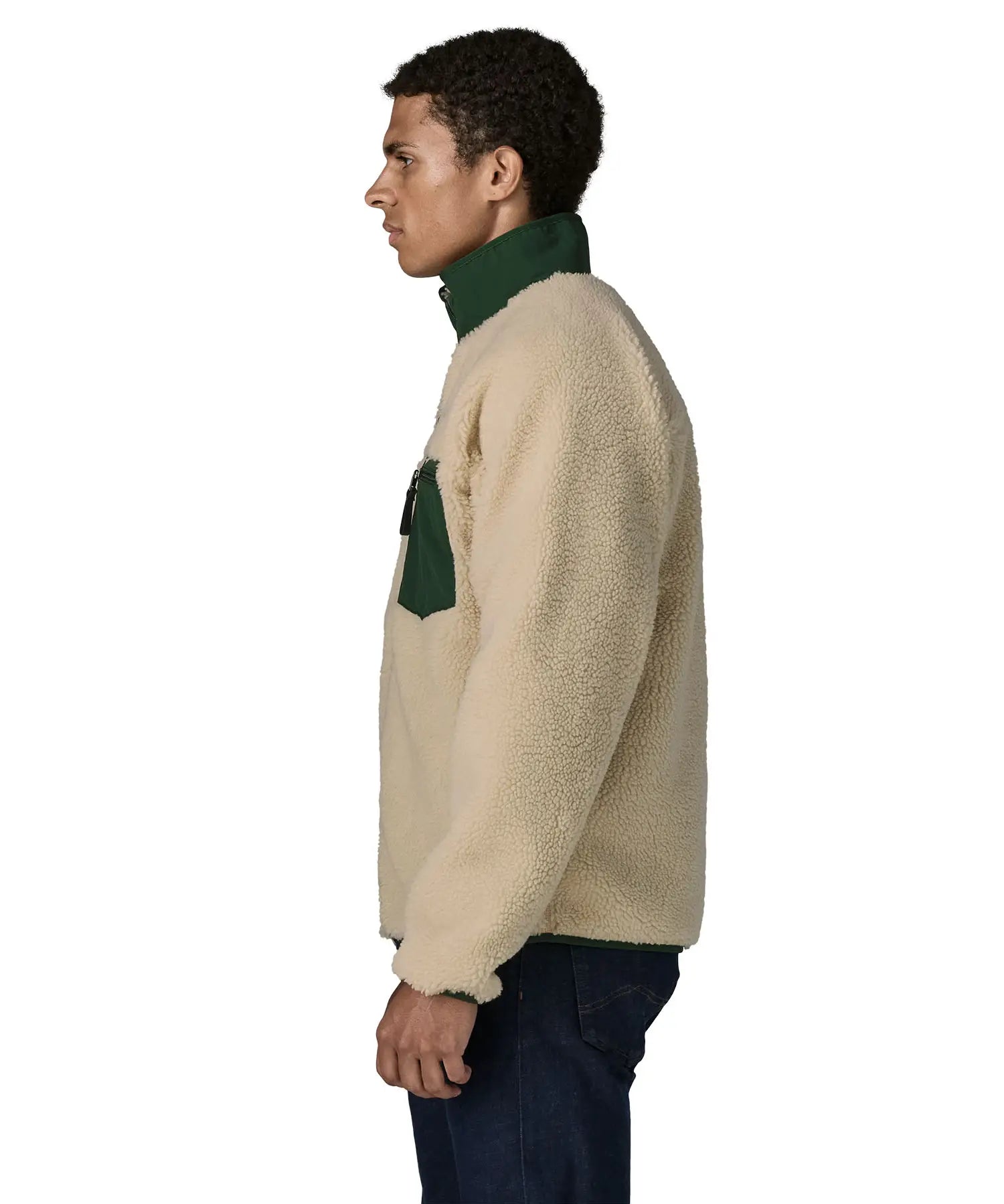 Side of man wearing the Patagonia classic retro x jacket in natural showing the green turned up collar and chest pocket. Fleece has a regular fit