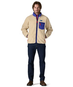 A man wearing the Patagonia classic retro x jacket in dark natural  available at Babipur.