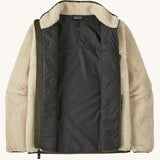 An open Patagonia men's thick fleece jacket in a cream colour showing the dark blue inner lining and fleece collar.