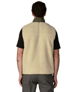Back of man wearing Patagonia's classic retro x warm fleece vest in beige with green trim. Gilet has a regular fit