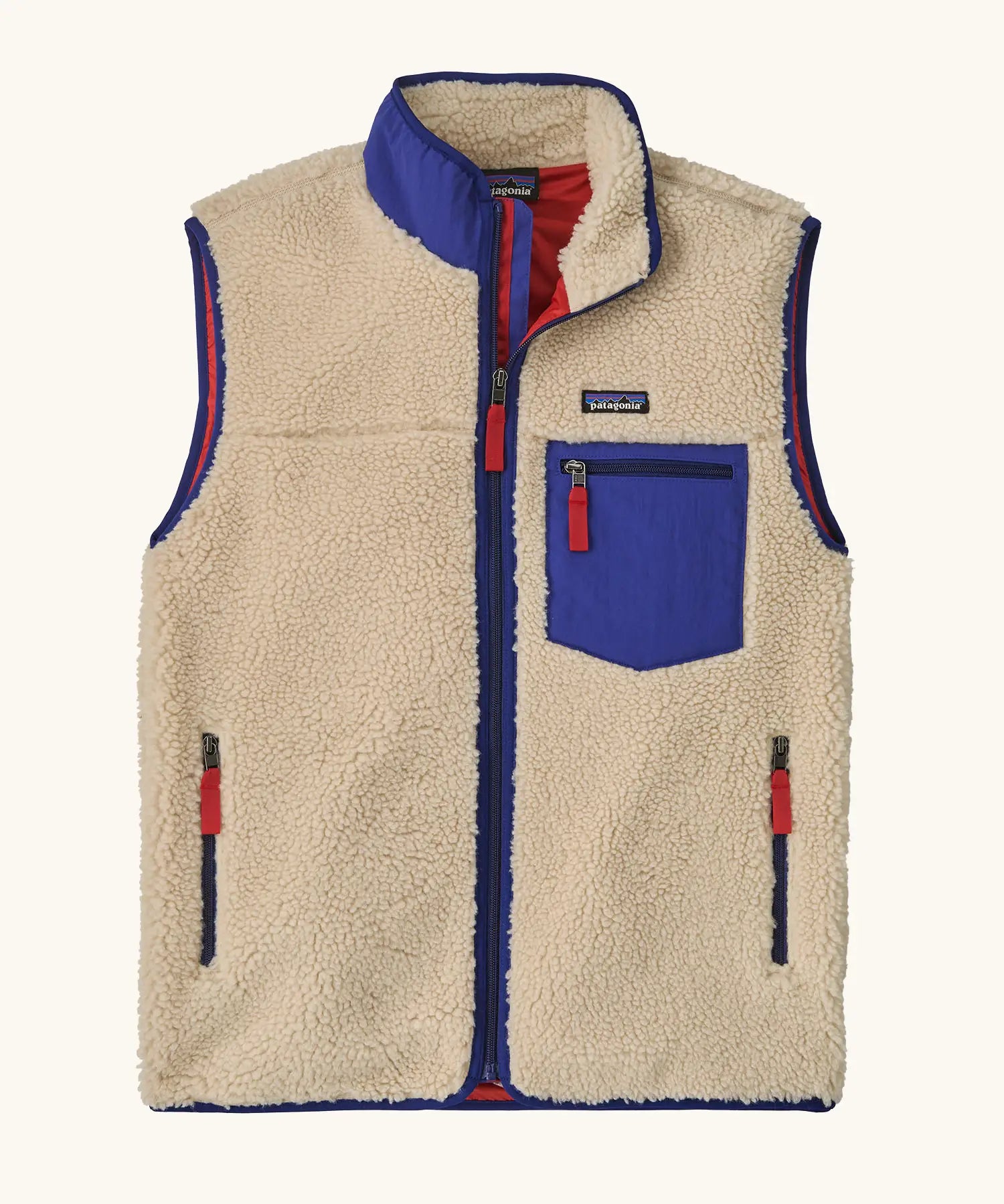Patagonia men's classic retro x warm fleece vest in beige with cobalt blue trim. Features a front zip, chest and side pockets
