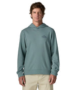 Front of man wearing a Patagonia cloud crag daily hoody in sage blue showing a small mountain print on upper chest